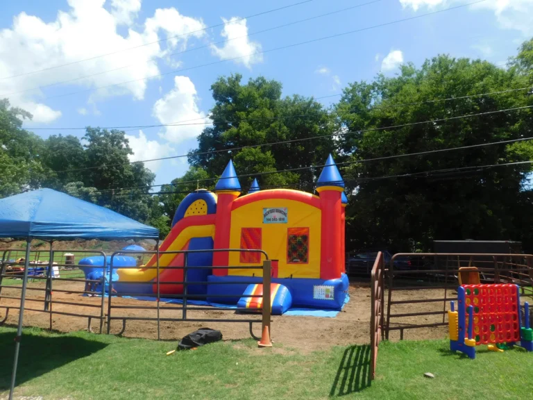 A bounce castle and lawn games wait for children on the grass