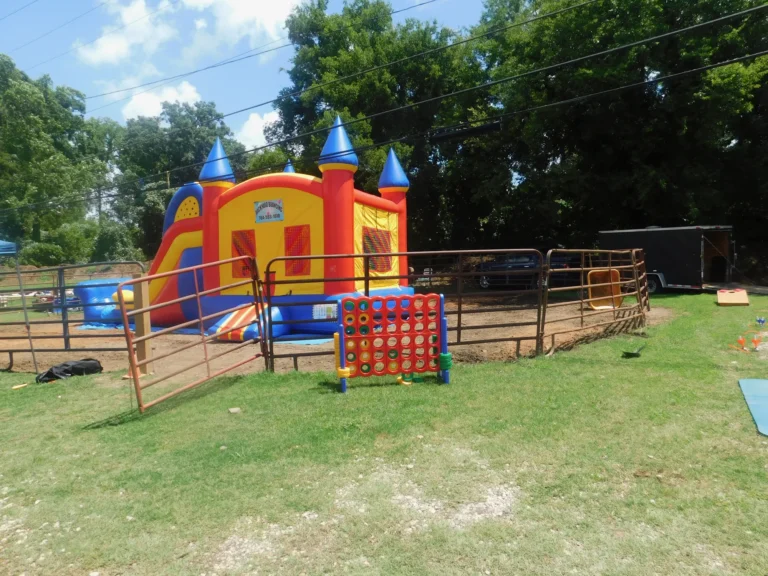 A bounce castle and a giant Connect Four game set up on the grass