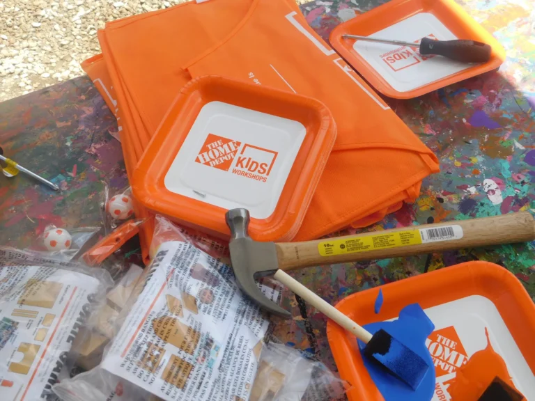 Home Depot Kids Workshop aprons, hammers and build kits ready on the table