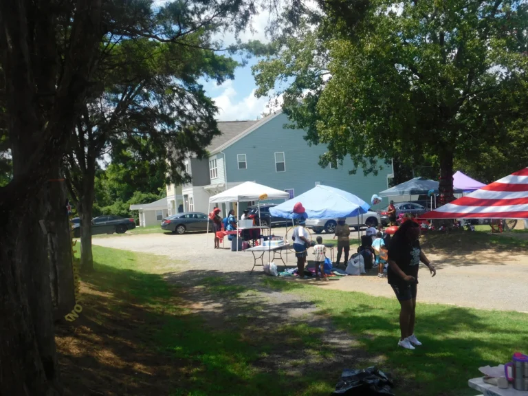 A shaded path leads down toward the vendor area