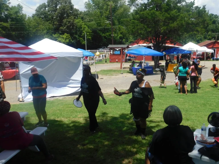 Guests play a lawn game beside the vendor canopies