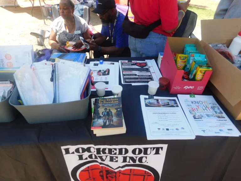 The Locked Out Love Inc. table with books and information sheets