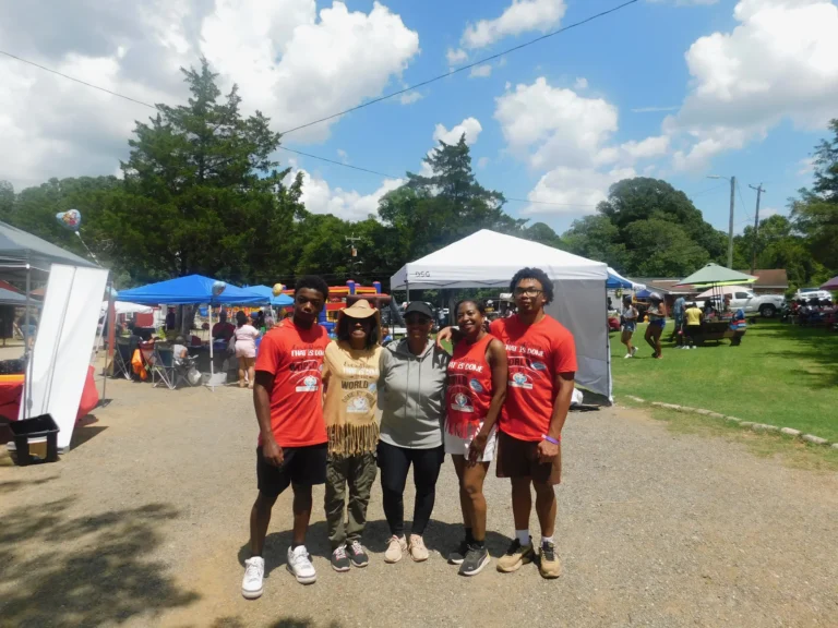 Volunteers in matching shirts gather together at the carnival
